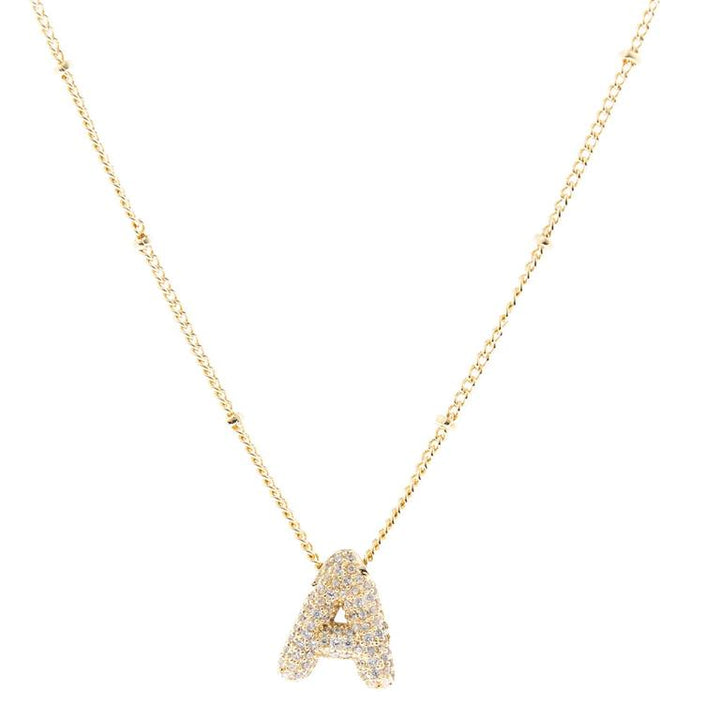 The Chloe Necklace features an "A"-shaped pendant with sparkling stones and delicate bead-like accents on an 18K gold-plated chain. Available in one standard size.