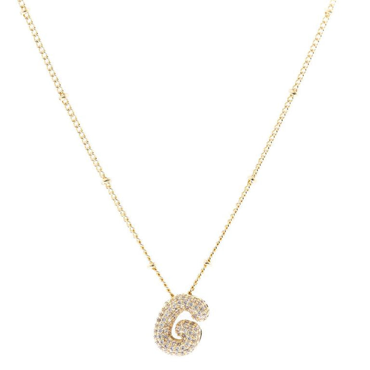 The Chloe Necklace is an 18K gold plated chain with small gold beads and a diamond-encrusted "G" pendant. Available in 16", 18", and 20" sizes.