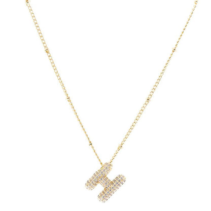 The Chloe Necklace features an "H" pendant with small diamonds, plated in 18K gold. Available sizes: 16-18 inches adjustable chain.