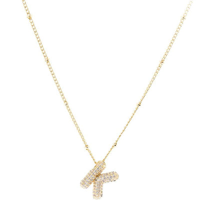 The Chloe Necklace showcases an 18K gold-plated 'K' initial pendant with sparkling diamonds on a delicate chain. Available sizes: Adjustable chain length from 16-18 inches.