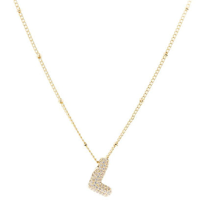 The Chloe Necklace features a delicate chain with an "L" pendant, adorned with sparkling diamonds and elegantly 18K gold plated. Available in one size.