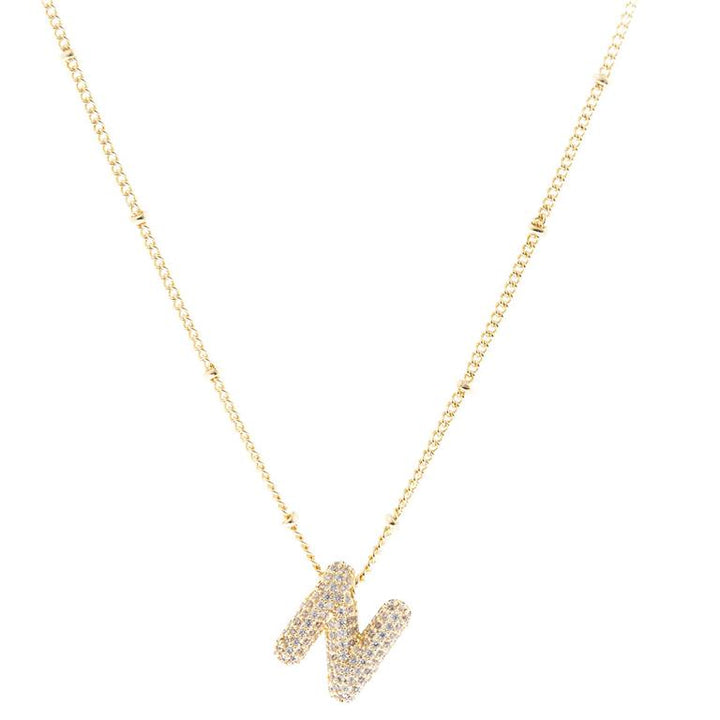 The Chloe Necklace has a gold chain with small, evenly spaced links and an "N"-shaped pendant encrusted with diamonds. Available in one size.