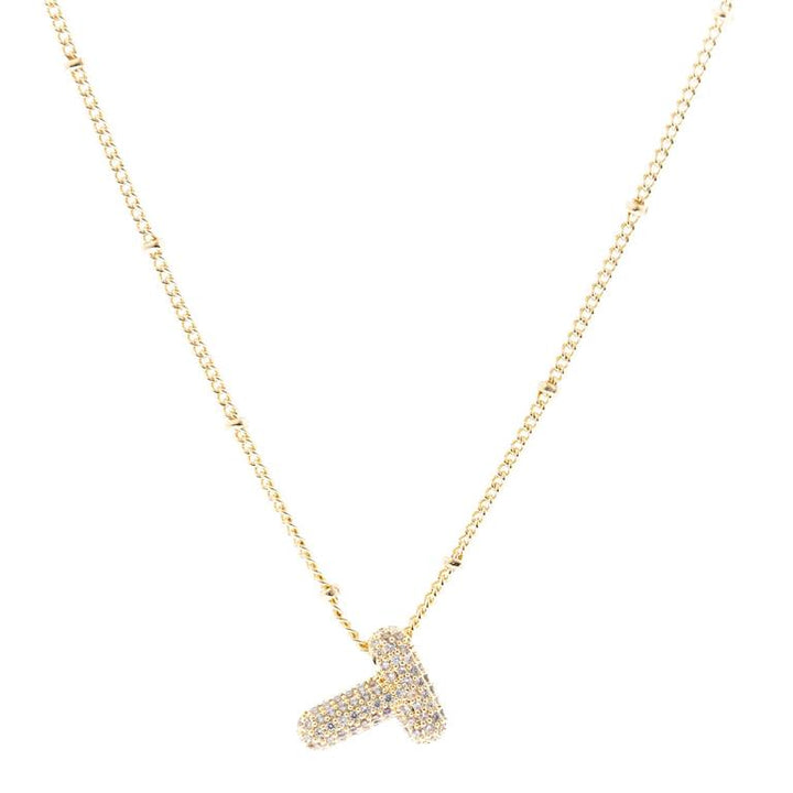 The Chloe Necklace features an 18K Gold Plated chain with a studded letter "T" pendant, embellished with tiny diamonds. Available in 16", 18", and 20" lengths.