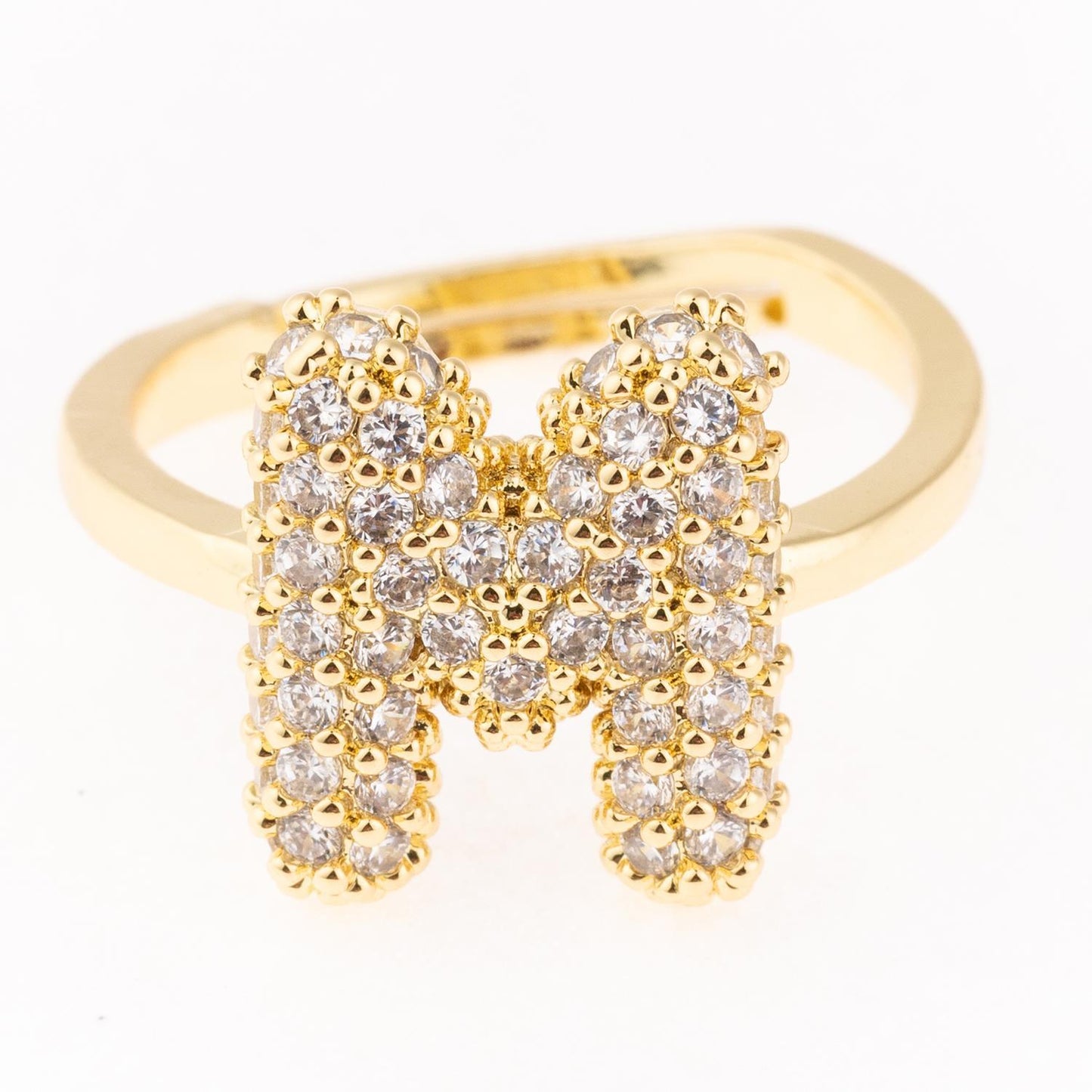 Gold plated hypoallergenic initial ring with bold "M" in clear gemstones. Available in sizes 5-9.