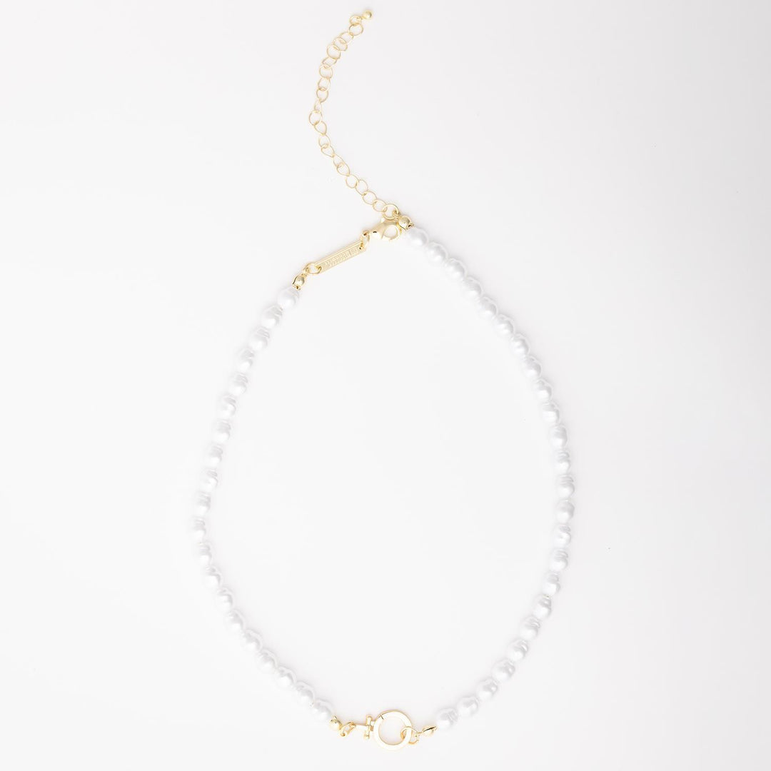 The Thea Charm Bar is a short 18k gold plated necklace with white pearls, gold hardware, chain extender, and clasp. Hypoallergenic for sensitive skin. Available in multiple lengths.
