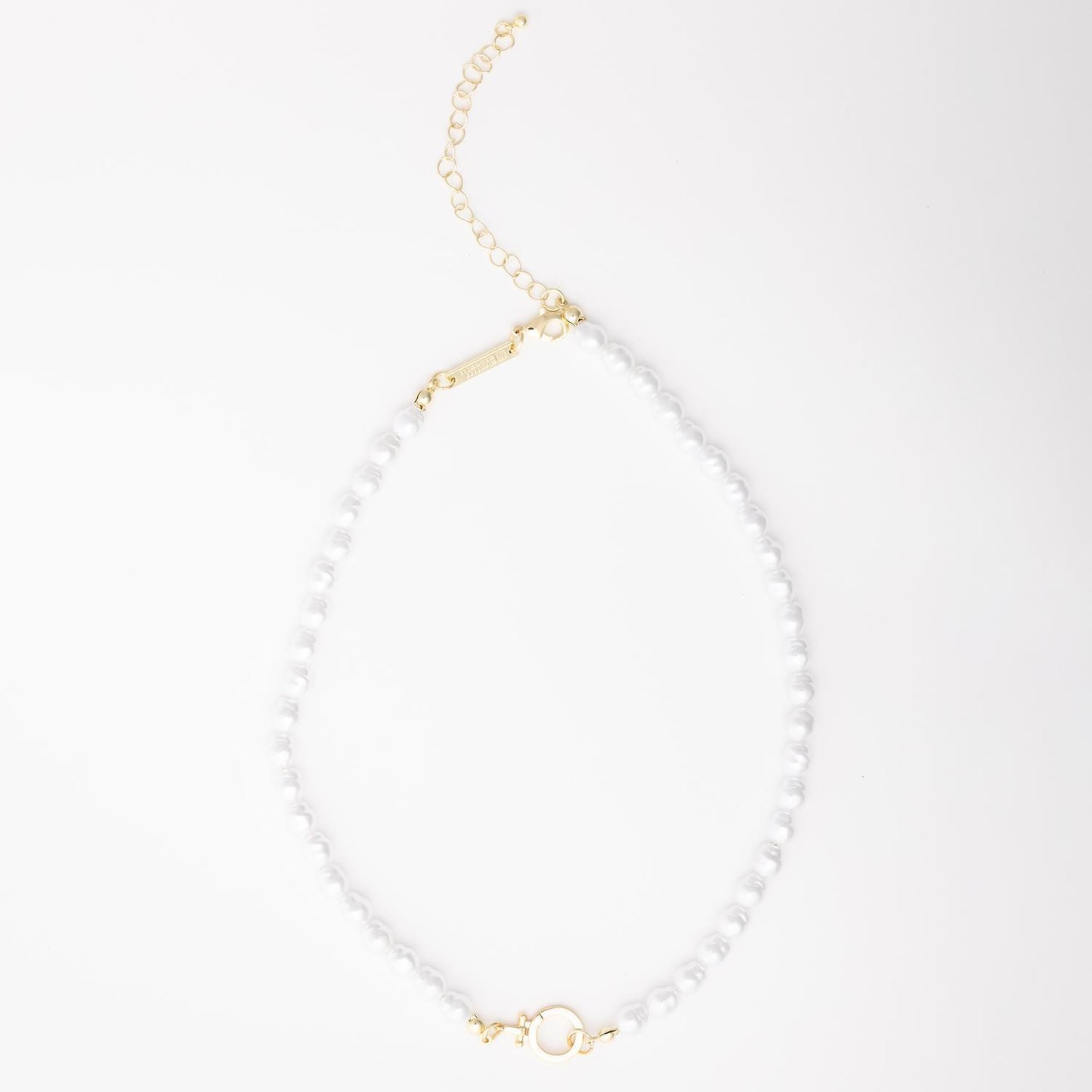 The Thea Charm Bar is a short 18k gold plated necklace with white pearls, gold hardware, chain extender, and clasp. Hypoallergenic for sensitive skin. Available in multiple lengths.