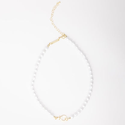 The Thea Charm Bar is a short 18k gold plated necklace with white pearls, gold hardware, chain extender, and clasp. Hypoallergenic for sensitive skin. Available in multiple lengths.