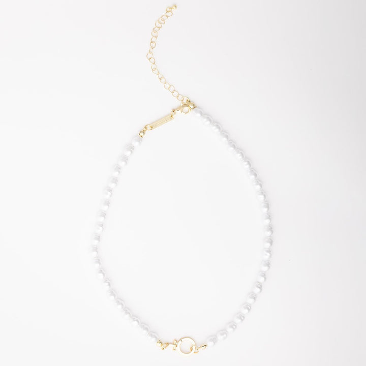The Thea Charm Bar is a short 18k gold plated necklace with white pearls, gold hardware, chain extender, and clasp. Hypoallergenic for sensitive skin. Available in multiple lengths.