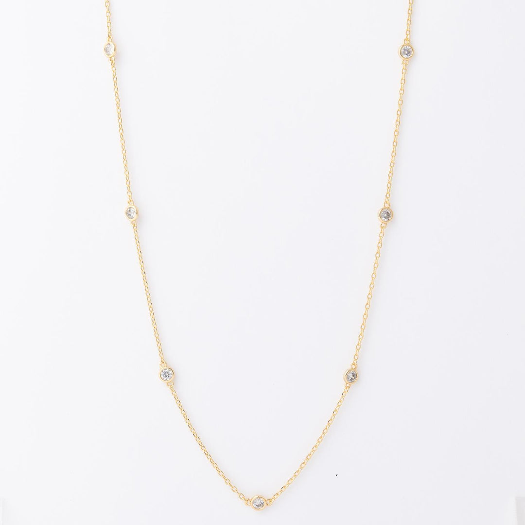 Gold necklace with evenly spaced small round gemstones on a fine chain. Available in 16", 18", and 20" lengths.
