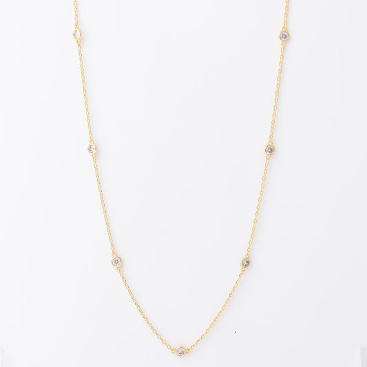 Gold necklace with evenly spaced small round gemstones on a fine chain. Available in 16", 18", and 20" lengths.
