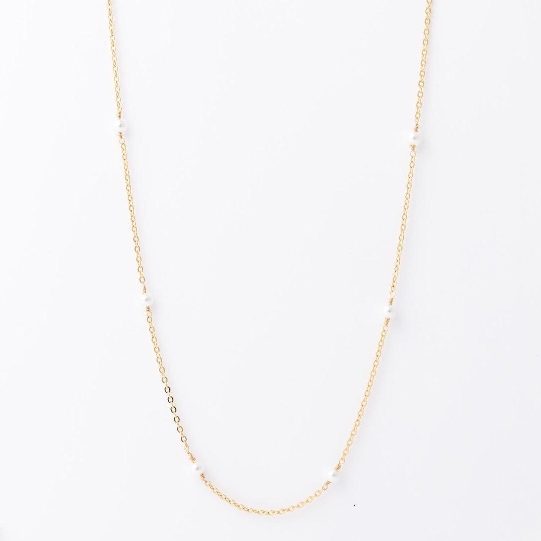 Lois Necklace: 18K gold-plated, features small, evenly spaced white pearls. Hypoallergenic. Available in 16", 18", and 20" lengths.