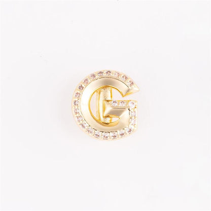 Gold "G"-shaped pin with clear gemstones outline. Available sizes: small, medium, large.