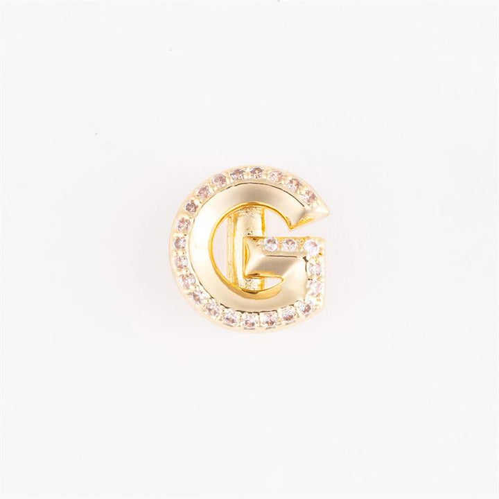 Gold "G"-shaped pin with clear gemstones outline. Available sizes: small, medium, large.