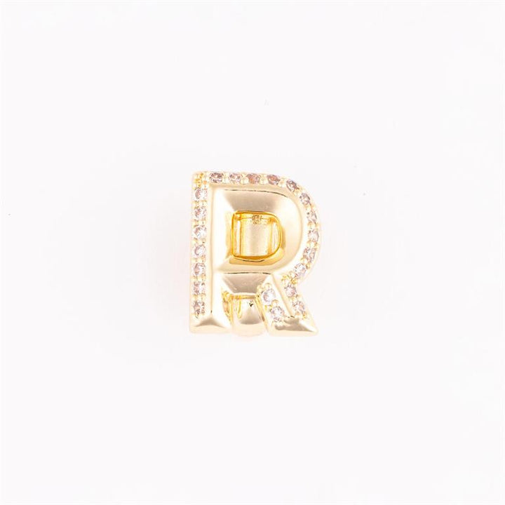 Gold letter "R" charm with clear gemstones on the edge. Available in S, M, L sizes.