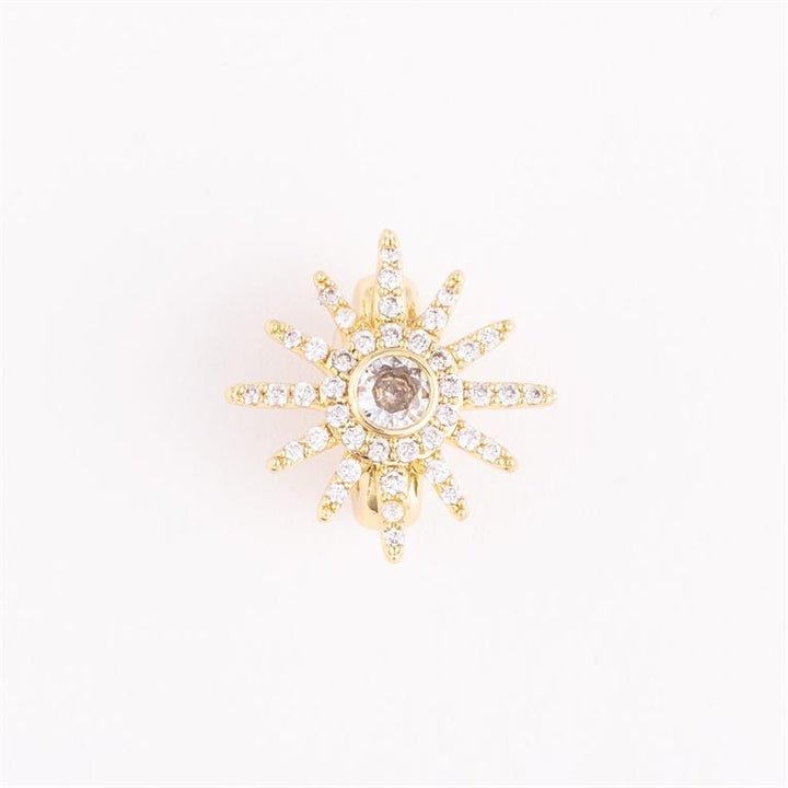Gold starburst earring with central brown gemstone and sparkling spokes. Available in small, medium, and large sizes.