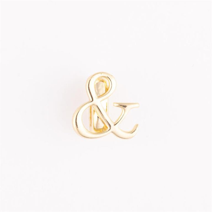 Shiny gold ampersand (&amp;) pin. Available sizes: small, medium, large.