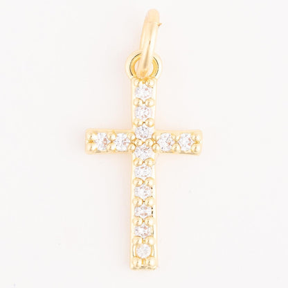 The Thea Charm Bar is an 18k gold plated necklace with a gold cross pendant set with small, round clear gemstones. Available in multiple sizes.