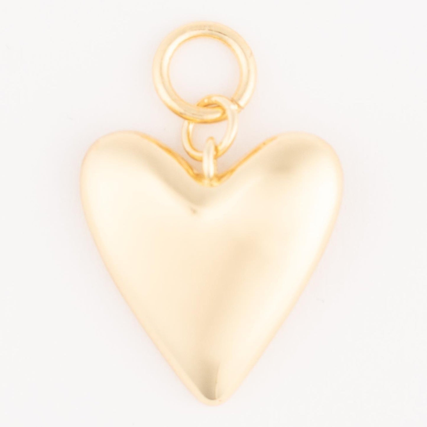 Shiny 18k gold-plated heart-shaped pendant with a small loop for attachment; hypoallergenic and customizable. Available in multiple sizes.
