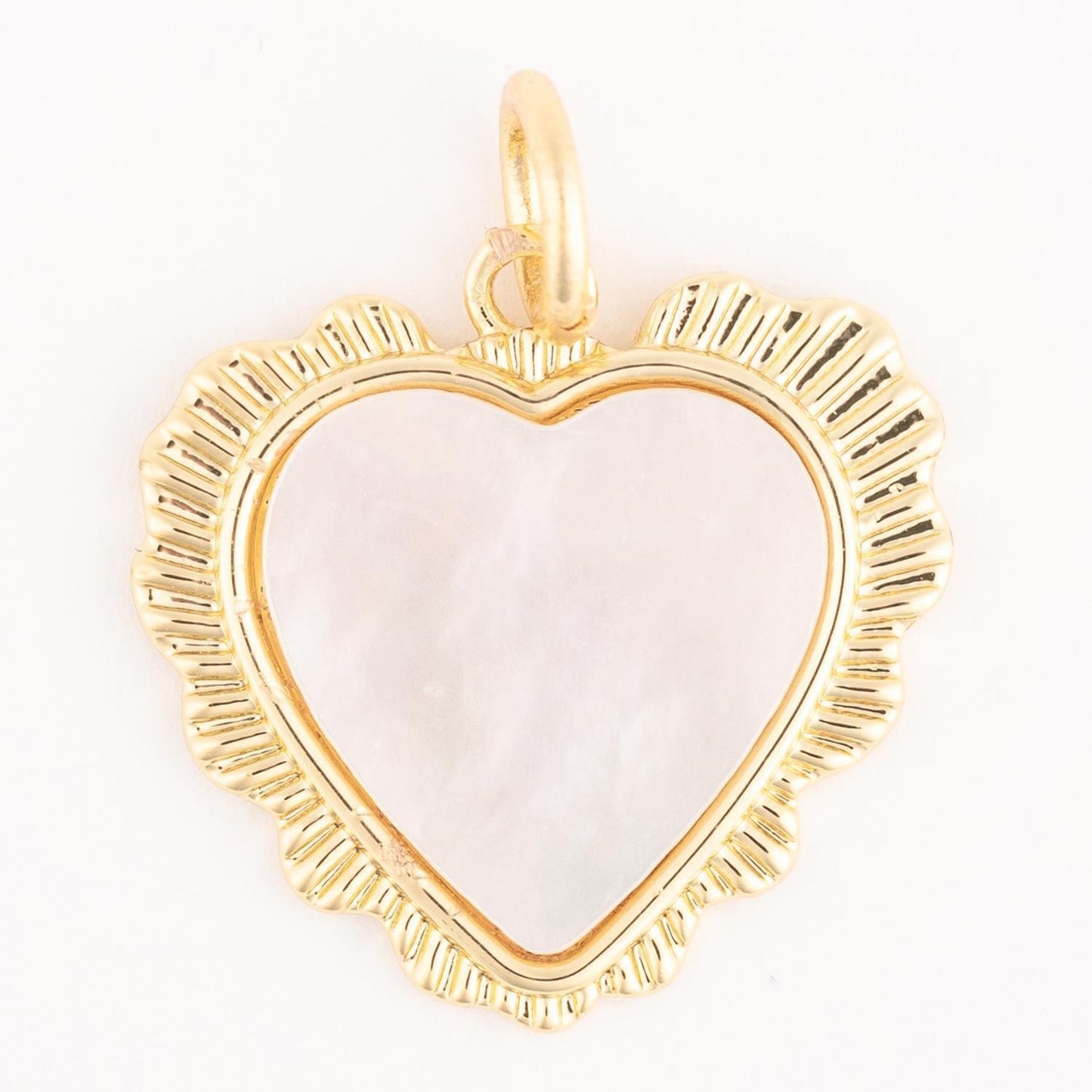 Elegant hypoallergenic 18k gold plated necklace with a heart-shaped pendant, featuring a textured scalloped border and smooth translucent white center, possibly mother of pearl. Customizable charm necklace. Available in multiple sizes.