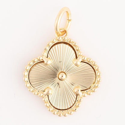 Gold clover-shaped pendant with beaded edge and sunburst center, finished in 18k gold plating. Hypoallergenic, includes a small loop for necklaces. Available sizes not specified.