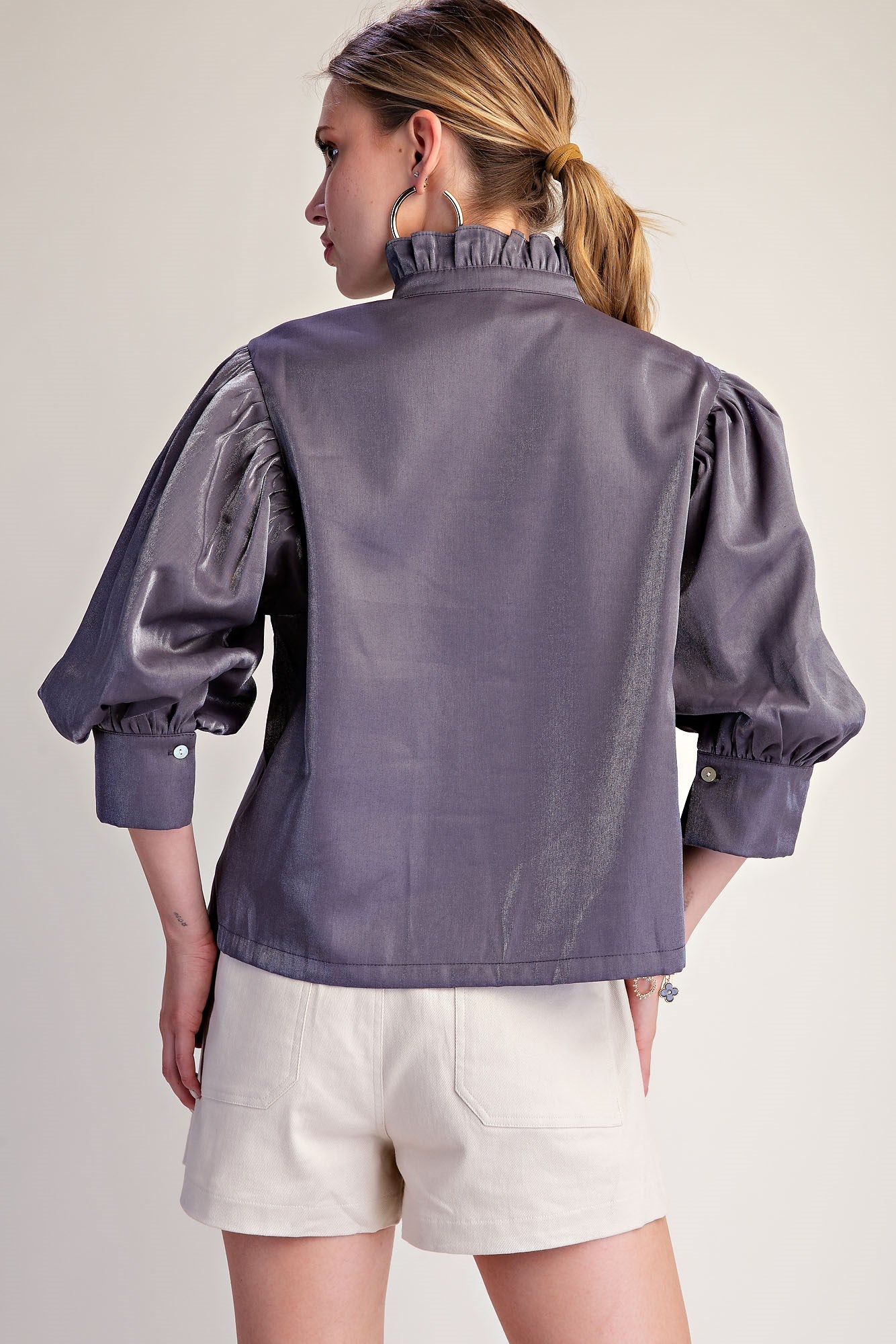 Silver Starlight Blouse in shiny purple metallic-effect fabric with ruffle neckline. Available in sizes XS–XL.