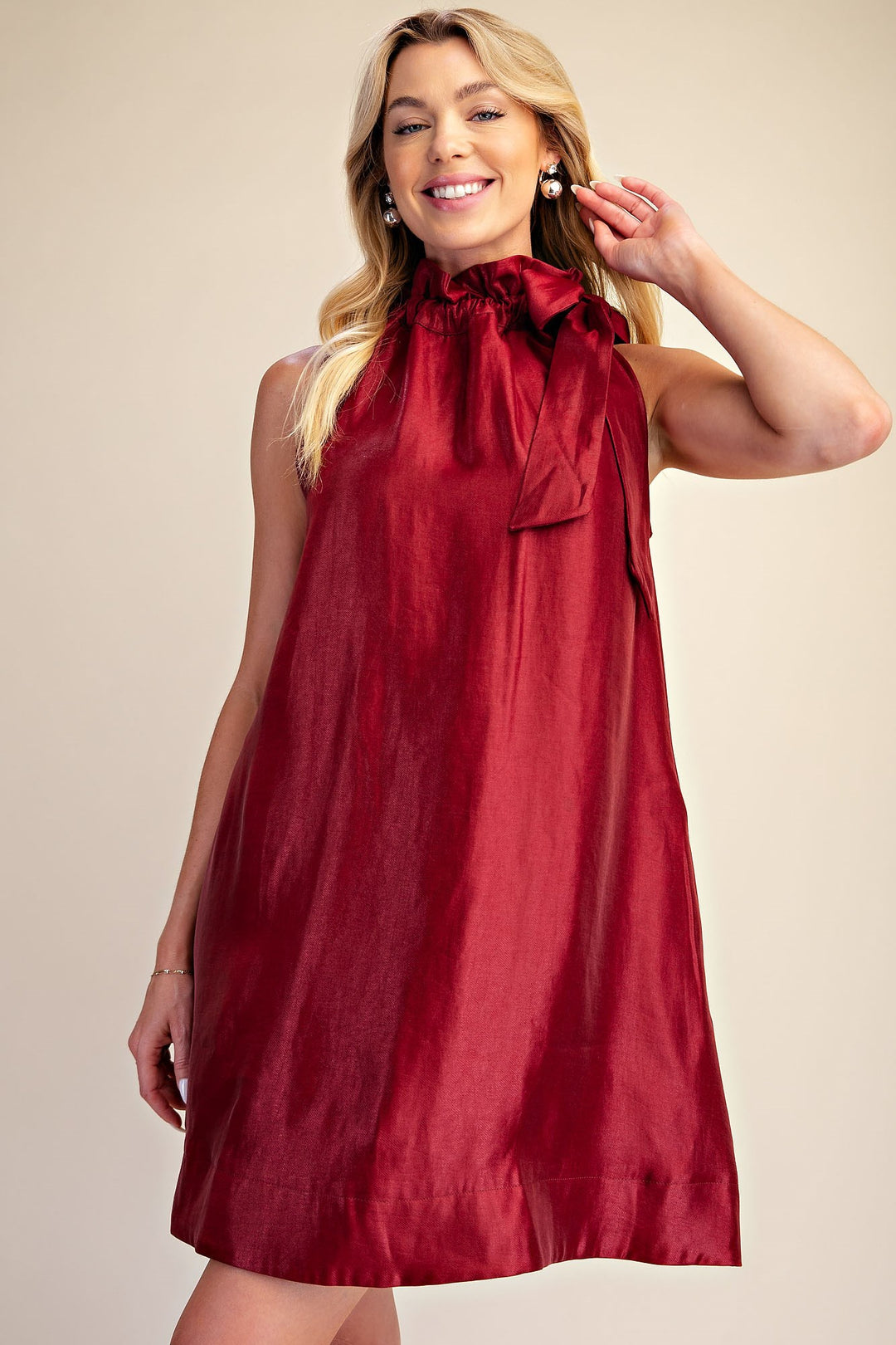 Camille Metallic Tie-Neck Dress: sleeveless, shiny red with high ruffled neckline and bow. Available in sizes XS–XL.