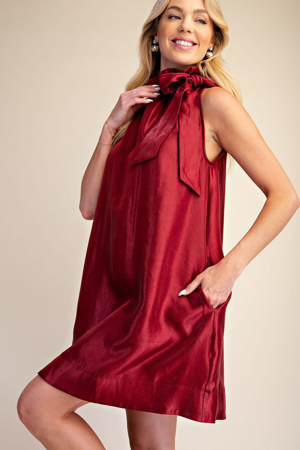 Camille Metallic Tie-Neck Dress, sleeveless, knee-length A-line with large bow at neck. Available in sizes XS-XL.