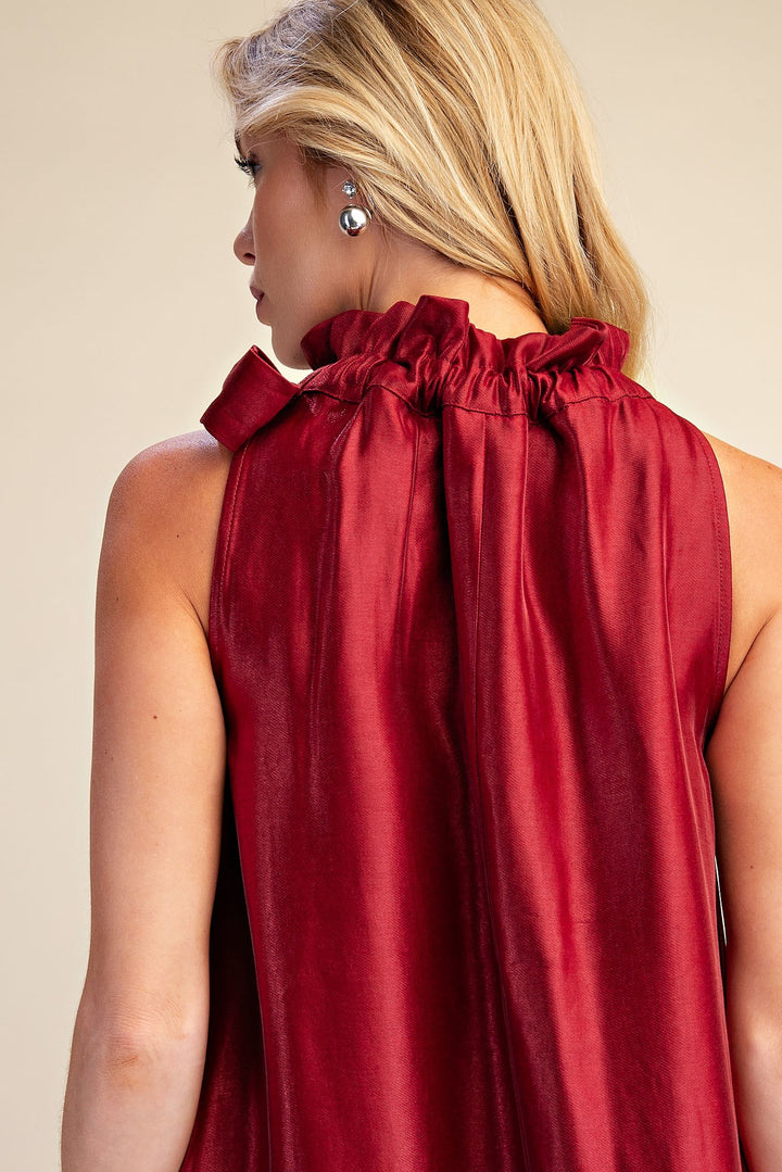 Camille Metallic Tie-Neck Dress: sleeveless, high neckline, ruffle details, A-line silhouette. Available in sizes 0–14.