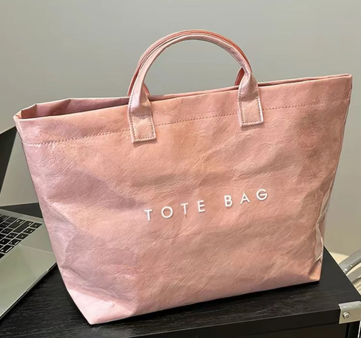 Large, light pink waterproof Vintage Tote Bag with white "TOTE BAG" print. Available sizes: large.