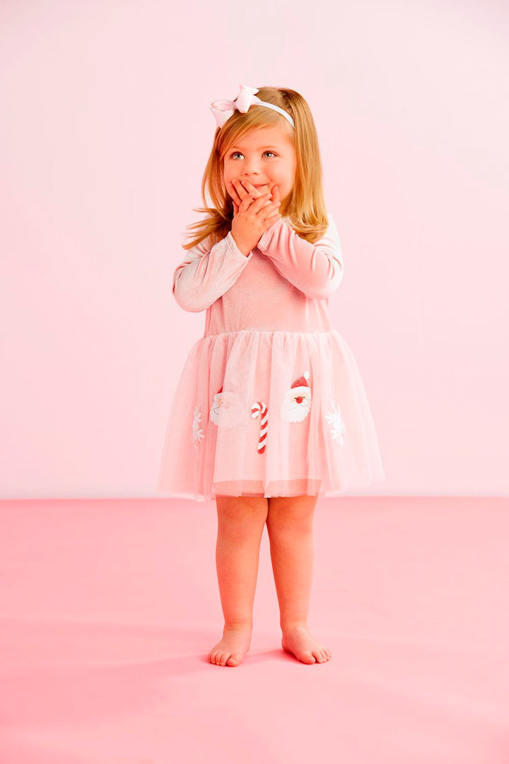 Pink sequin tutu dress with long sleeves, pink velour bodice, and mesh skirt with Santa and candy cane appliqués. Available in various sizes.