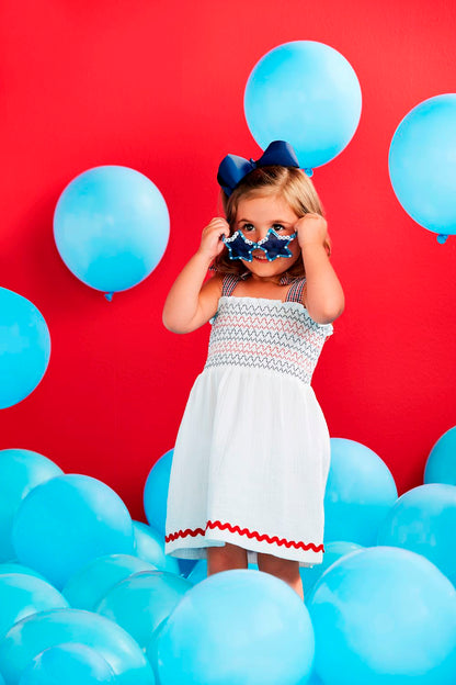 The White Smocked Gauze Toddler Dress is a charming outfit for young girls. Sizes available: 2T, 3T, 4T, and 5T.
