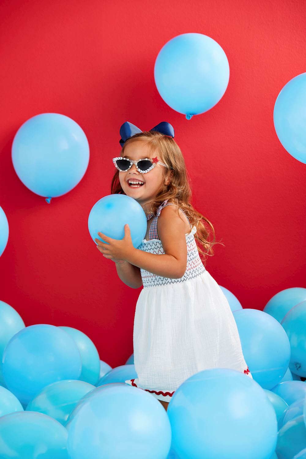White Smocked Gauze Toddler Dress: A charming dress featuring elegant smocking, perfect for playful occasions. Sizes available: 2T, 3T, 4T, and 5T.