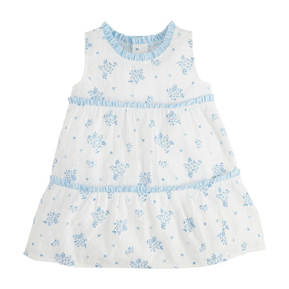 The Blue Floral Tiered Toddler Dress is a sleeveless white cotton dress with blue floral prints, ruffled trim, and a flared design. Available in sizes 2T, 3T, 4T, and 5T.