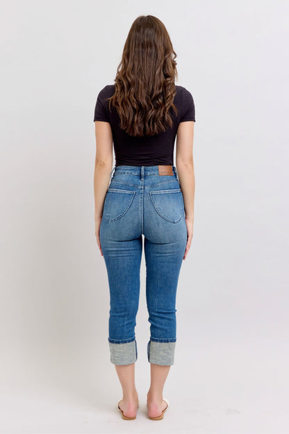 Judy Blue HW Tummy Control Back Shield Pkts & Cuff Capri jeans; available in sizes 0–22.