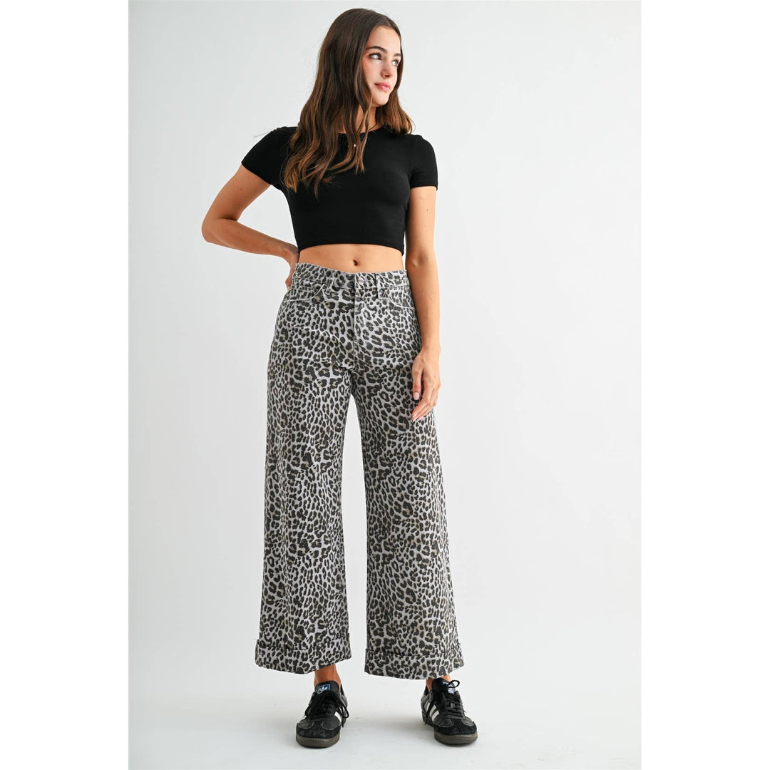 High-rise, wide-leg, cropped leopard print jeans in grey and black with cuffed hems, size 31.