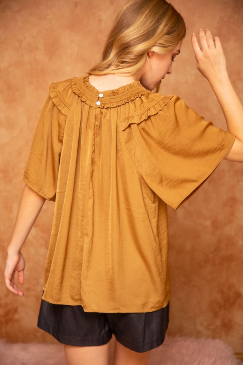 Ruffle Round Neck Golden Top with subtle shine, available in sizes XS-XL.