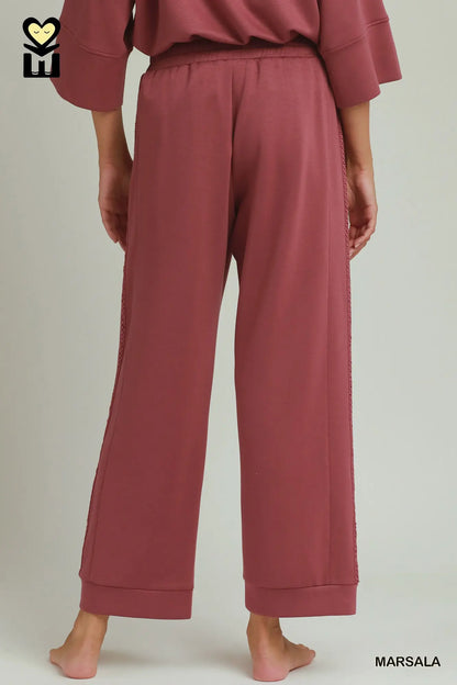Loose-fitting, wide-legged marsala Butterfly Lace Straight Leg Pants with visible side seams and relaxed fit. Available in sizes XS-XL.