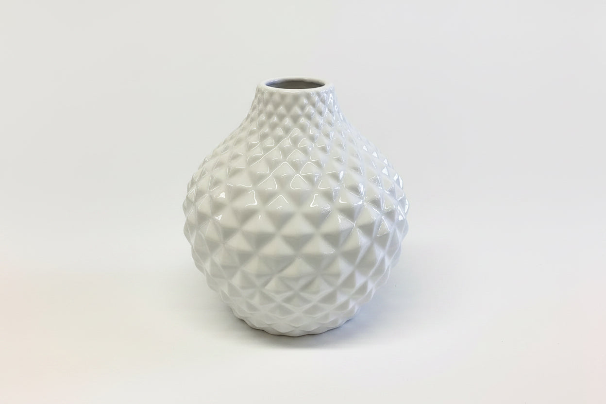 White ceramic vase with rounded shape and textured geometric diamond pattern. Available in multiple sizes.