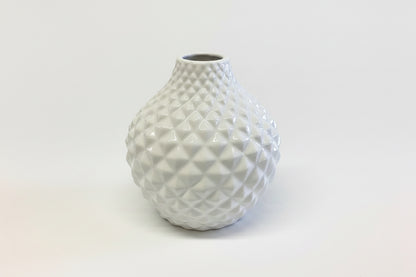 White ceramic vase with rounded shape and textured geometric diamond pattern. Available in multiple sizes.
