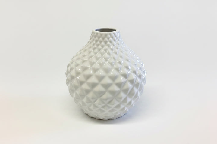 White ceramic vase with rounded shape and textured geometric diamond pattern. Available in multiple sizes.