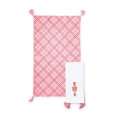 Set of 2 Nutcracker dish towels with tassels, one pink and white plaid, one solid white with Nutcracker motif.
