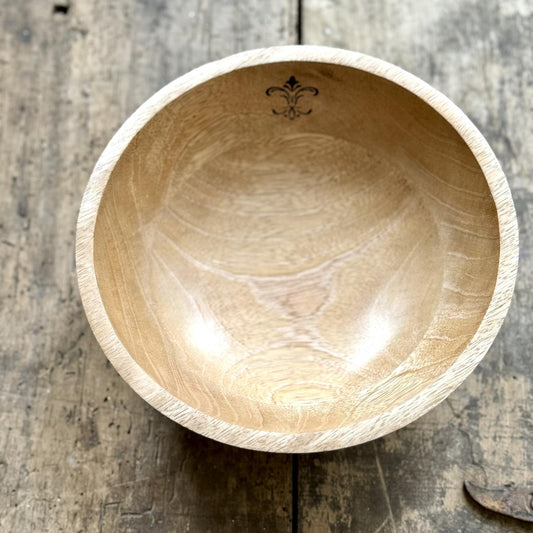 Handmade 10" round mango wood bowl with a smooth, polished finish. Features unique wood grain patterns and an ornamental design carved near the rim. Sizes available: 10".