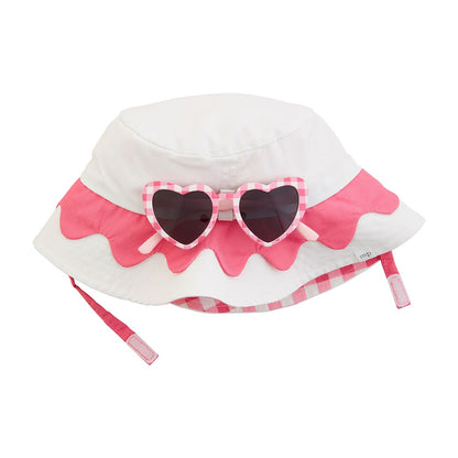 The Pink Hat & Sunglasses set features a white and pink sun hat with a scalloped design, gingham ribbon, and UPF 50+ protection. Includes heart-shaped sunglasses with pink checkered frames and UV400 black lenses. Sizes: S, M, L.