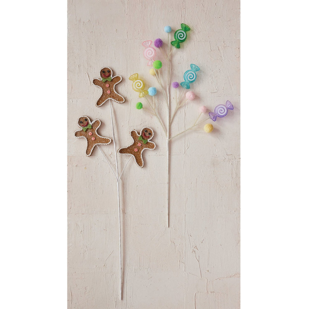 Two decorative holiday sprays: one with three gingerbread cookie figures, one with colorful candy ornaments and pom-poms.