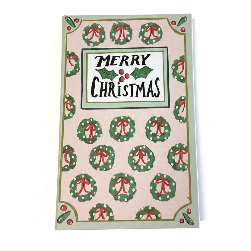 Rectangular multicolor canvas book storage boxes with a wreath pattern and “MERRY CHRISTMAS” text.