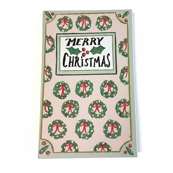 Rectangular multicolor canvas book storage boxes with a wreath pattern and “MERRY CHRISTMAS” text.