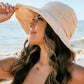 Tie-back Bucket Sunhat: Lightweight sunhat with wide brim and adjustable tie-back. Sizes available: S, M, L.
