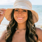 White Tie-back Bucket Sunhat made from lightweight, breathable fabric. Offers adjustable tie back for a secure fit. Sizes available: S, M, L.
