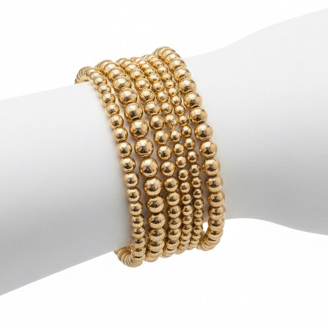 Hunter 6-Strand Stretch Bracelet Stack with six gold and silver beaded stretch bracelets in various bead sizes. Sizes available: S, M, L.