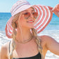 Stripe Bow Accent Sunhat: Striped pink-and-white sunhat with a decorative bow. Available in sizes S, M, and L.